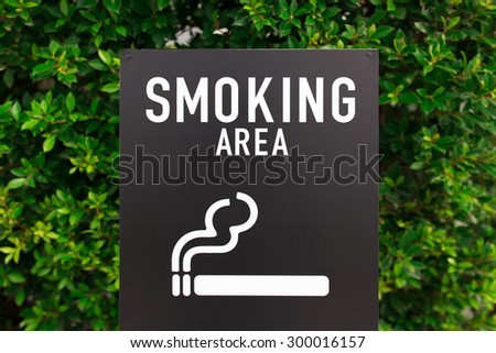 smoking area sign on bush wall
