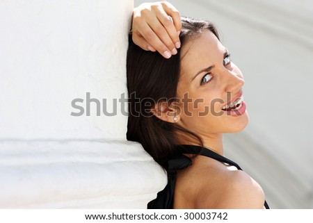 Beautiful woman standing against wall in background