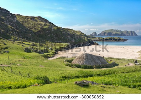 Ancient blackhouse or celtic croft preserved and restorend on a beach on Lewis in the Ouder Hebrides of Scotland Royalty-Free Stock Photo #300050852