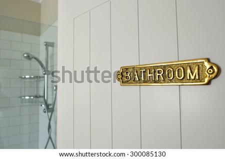 Bathroom sign on a home bathroom door of a shower room. No people. Copy space