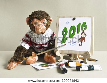 2016 - the year of the monkey. Toy monkey - painter