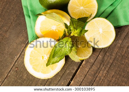 ripe citrus on wooden background. Lime and lemon