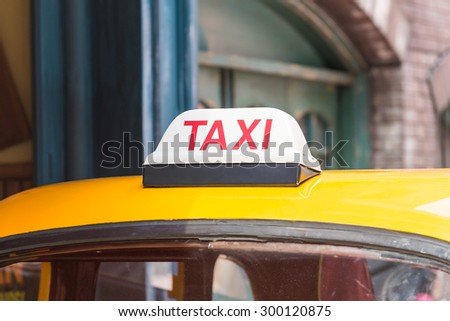 Taxi sign on roof top car