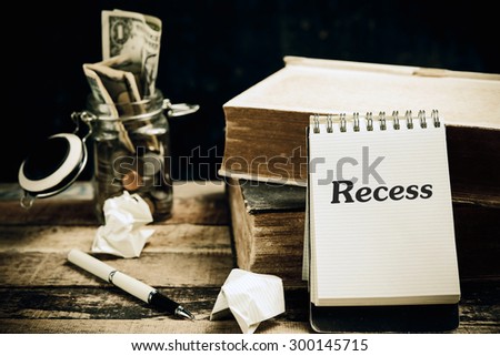 Recess word book on wood table vertical 