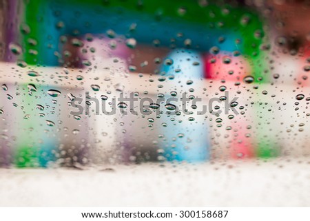 rain on glass with soft focus color filtered background