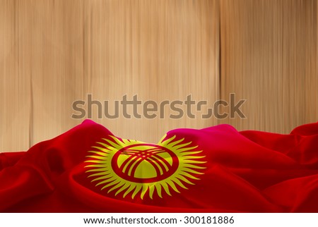 Kyrgyzstan flag and wood background