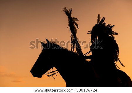 The Indians are riding a horse and spear ready to use In light of the Silhouette Royalty-Free Stock Photo #300196724