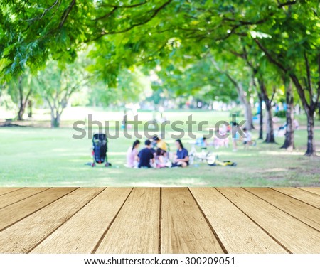 Perspective wood with blurred people activities in park background, spring and summer