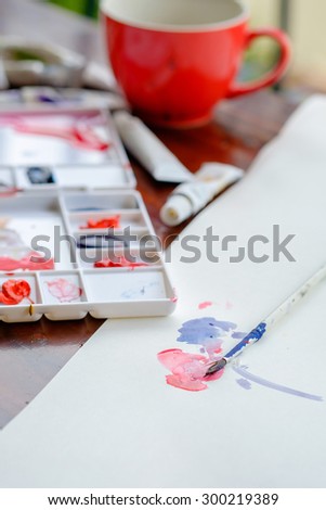 Artist palette , water colors and paintbrushe