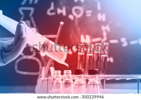Laboratory research, dropping chemical liquid to test tubes