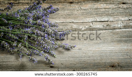 Lavender flowers on wooden background. Vintage style toned picture