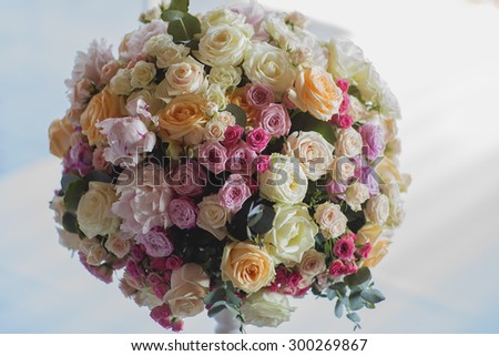 Wedding posy of fresh beautiful flowers of roses and peony white pink violet purple yellow lilac and orange colours round shape indoor closeup, horizontal picture