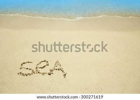 a the word "sea" in the sand on the beach