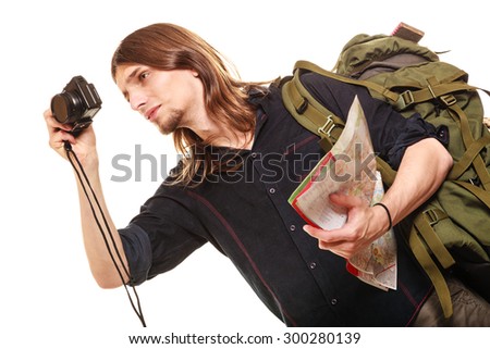 Man tourist backpacker on trip taking photo picture with camera. Young guy hiker backpacking holding map. Summer vacation travel. Isolated on white background.