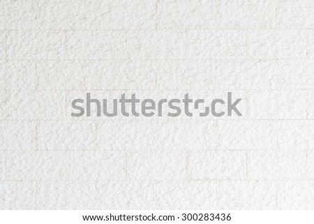 Modern rough marble rock tiled detail wall texture pattern background in pastel white grey