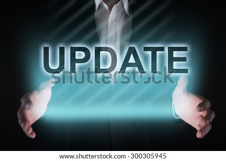 Glowing text "update" in the hands of a businessman. Business concept