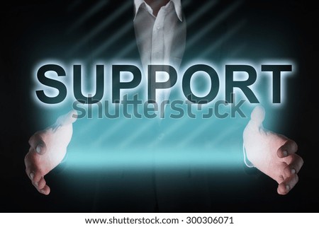 Glowing text "support" in the hands of a businessman. Business concept
