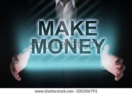 Glowing text "make money" in the hands of a businessman. Business concept.