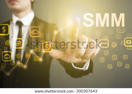 Businessman pressing button on the virtual screen and select "SMM". business concept. Internet concept.