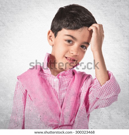 Child combing over grey background
