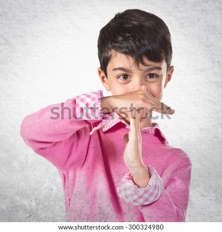 Boy making time out gesture  