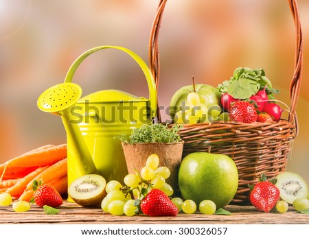 Garden concept, fresh fruits and vegetables on wooden table, autumn background