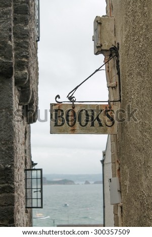 Old Rusty Book Sign on a wrought iron hanging bracket