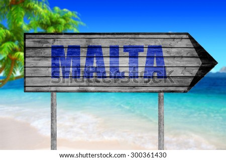 Malta wooden sign with beach background
