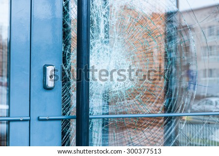 Broken glass front door Royalty-Free Stock Photo #300377513