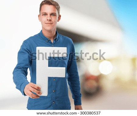 happy young man with f letter