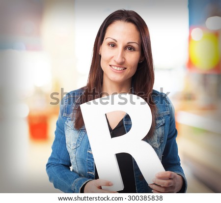 woman holding the R letter