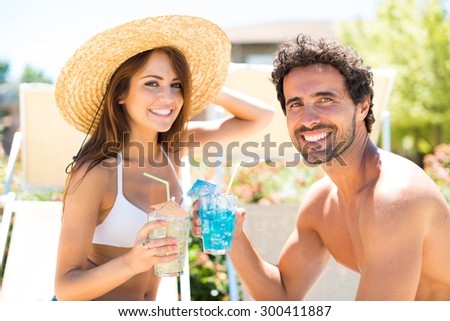 Portrait of a beautiful young couple enjoying a cocktail while talking