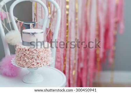Elegant two-tier birthday or wedding cake with ruffled fondant bottom. Hand decorated artisanal cake. Tilt-shift effect.