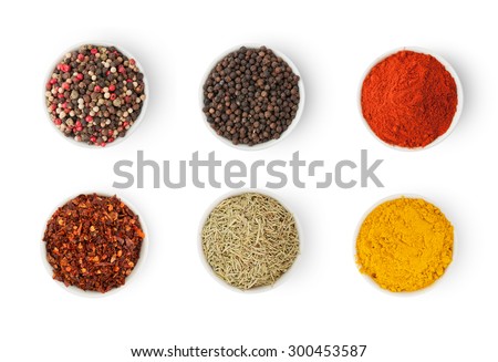 Spices in a bowls isolated on white background, top view Royalty-Free Stock Photo #300453587