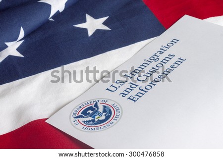 US Customs and Border Enforcement and USA flag Royalty-Free Stock Photo #300476858