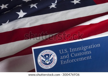 US Customs and Border Enforcement and USA flag Royalty-Free Stock Photo #300476936