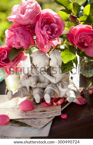 A happy couple in love .Stack of vintage letters and background image of pink french roses