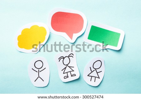 Paper children with colorful blank dialog speech bubbles.