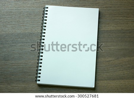 blank spiral notebook on dark wood background