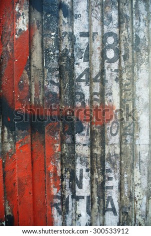 Photograph of urban random collage background or paper texture with red paint