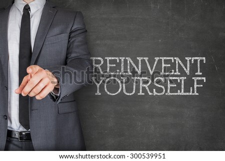 Reinvent yourself on blackboard with businessman finger pointing