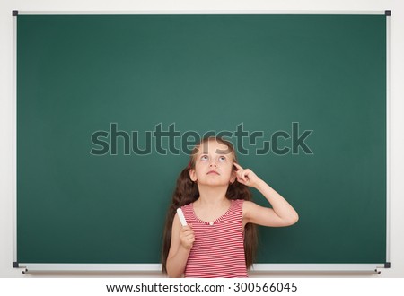 girl with chalk write on school board