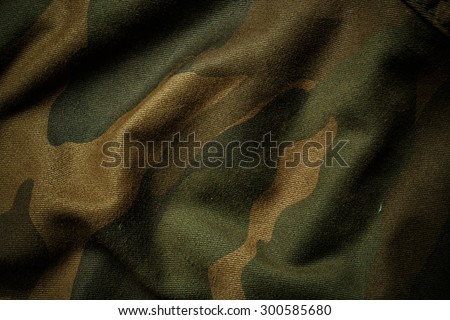 Camouflage fabric texture background Royalty-Free Stock Photo #300585680