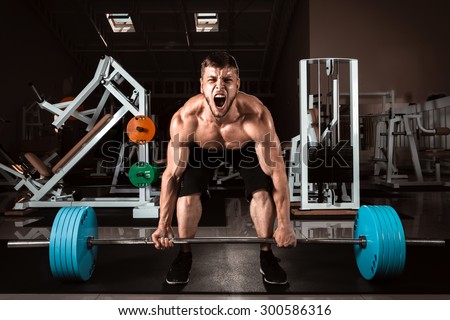 Muscular Man Doing Heavy Deadlift Exercise Royalty-Free Stock Photo #300586316