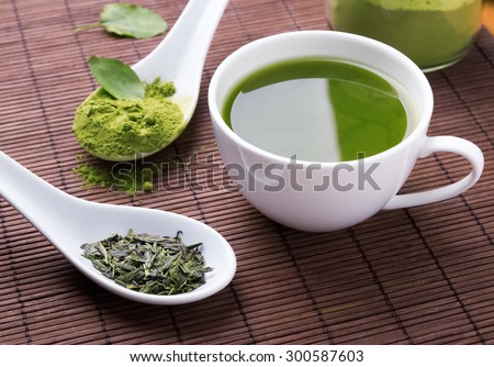 Green tea n the brown mat close-up Royalty-Free Stock Photo #300587603
