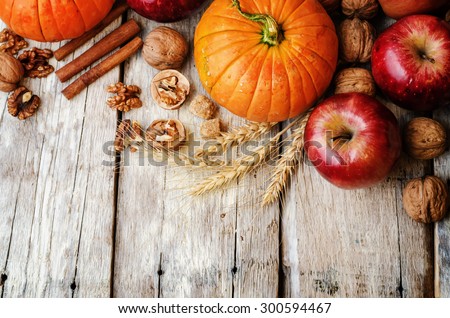 wood background with pumpkin, apples, wheat, honey and nuts. the toning. selective focus