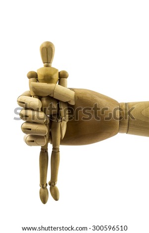 Big hand holds small wooden man