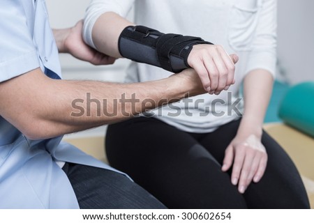 Woman using wrist immobiliser after hand's injury Royalty-Free Stock Photo #300602654
