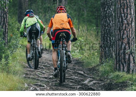 two cyclist  mountainbiker during a race in the woods Royalty-Free Stock Photo #300622880