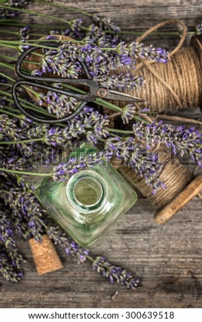 Herbal oil essence and lavender flowers. Vintage decoration. Top view. Retro style toned picture. Selective focus